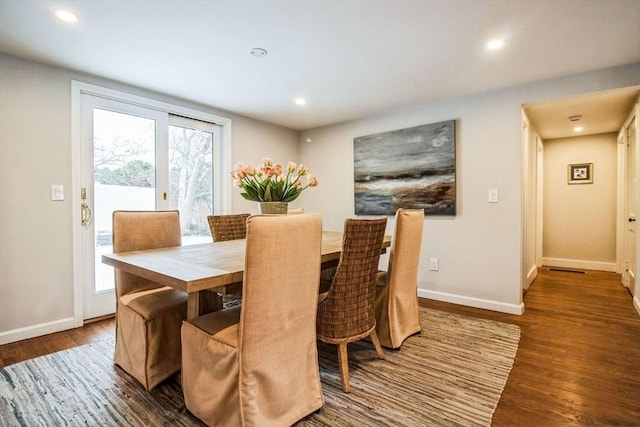 dining room featuring dark wood-type flooring and a wealth of natural light