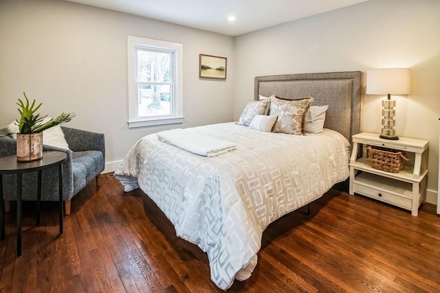 bedroom with dark hardwood / wood-style floors