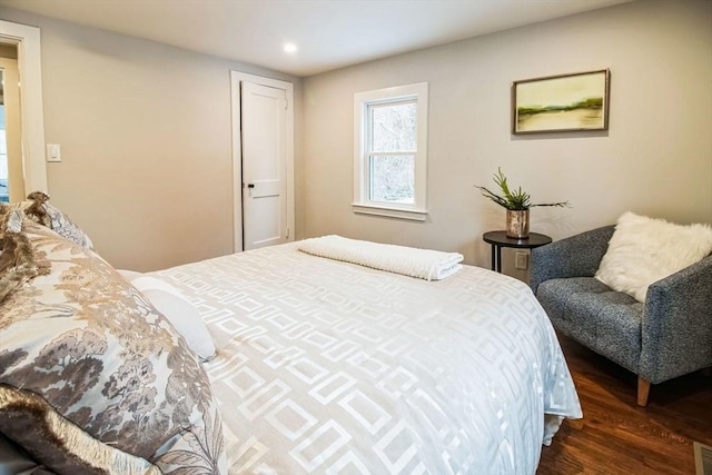 bedroom with dark hardwood / wood-style floors