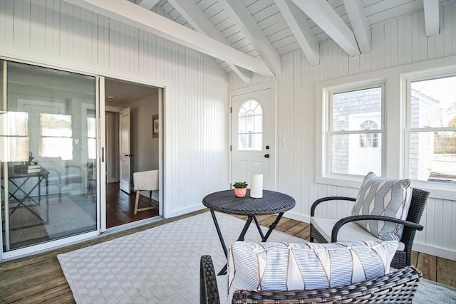 sunroom with a wealth of natural light and vaulted ceiling with beams