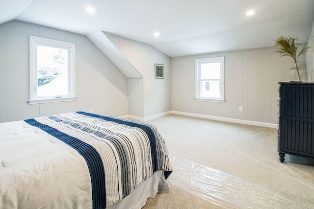 carpeted bedroom with lofted ceiling