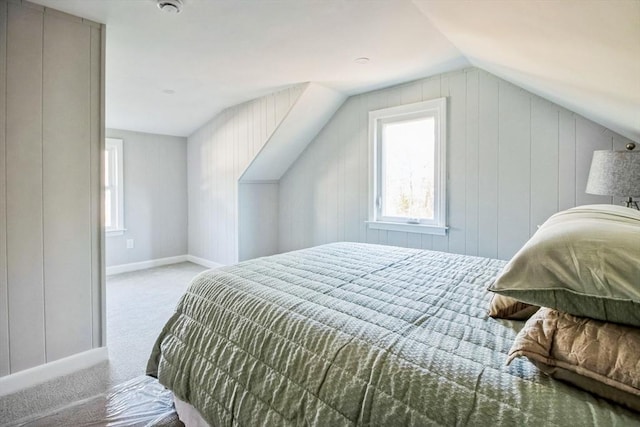 bedroom with light carpet and lofted ceiling