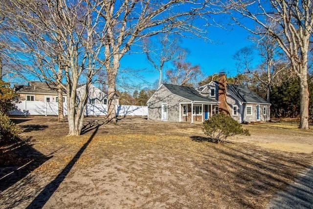 view of side of home with a yard