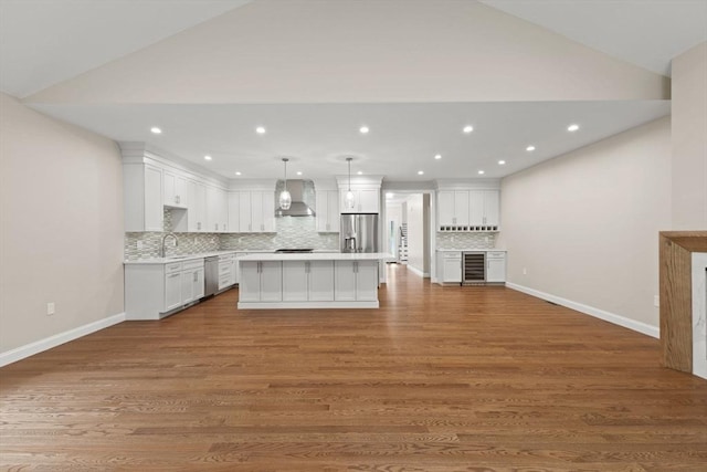 11 Olde Stable Ln, Easton, MA 02356 - kitchen with appliances with stainless steel finishes, beverage cooler, wall chimney exhaust hood, light countertops, and white cabinets