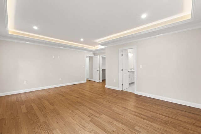 11 Olde Stable Ln, Easton, MA 02356 - spare room with a raised ceiling, light wood-style floors, recessed lighting, and crown molding
