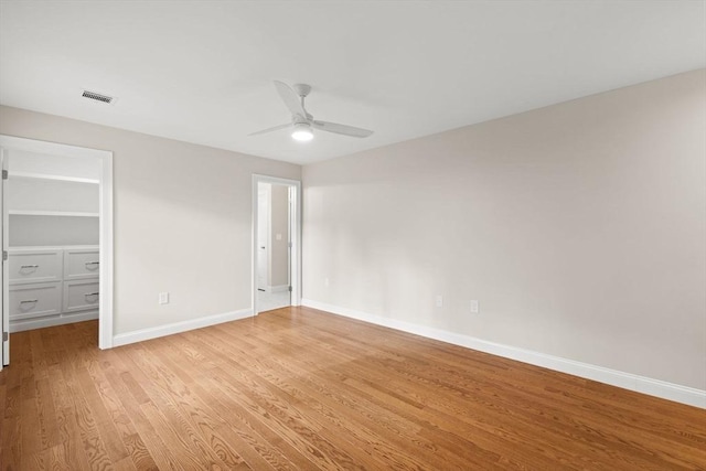 11 Olde Stable Ln, Easton, MA 02356 - unfurnished bedroom with light wood finished floors, a walk in closet, a ceiling fan, and a closet