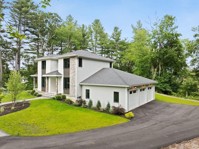11 Olde Stable Ln, Easton, MA 02356 - view of front of home featuring a front lawn, a shingled roof, a garage, asphalt driveway, and stone siding