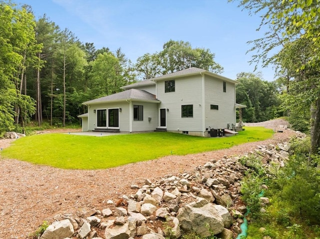11 Olde Stable Ln, Easton, MA 02356 - back of property with a lawn, a patio area, and entry steps