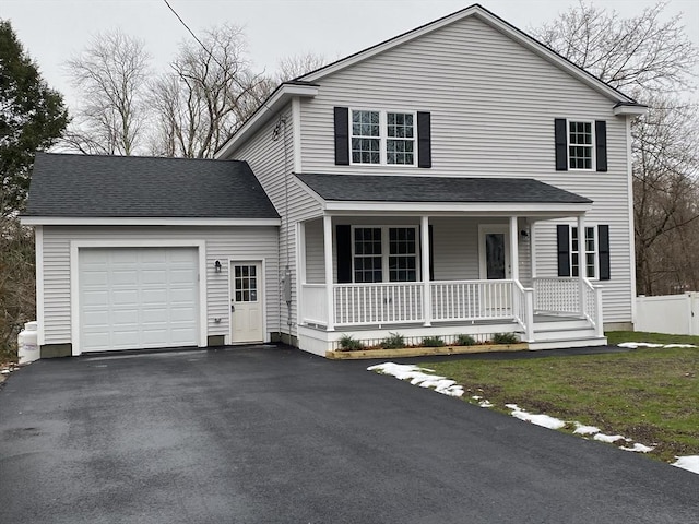 view of front facade featuring a porch and a garage