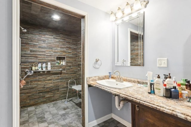 bathroom with sink and tiled shower