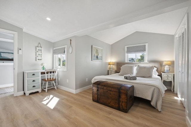 bedroom with light wood-type flooring, baseboards, and multiple windows