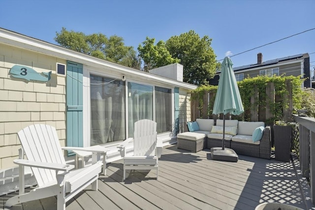wooden terrace featuring an outdoor living space