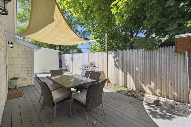wooden deck with fence and outdoor dining area