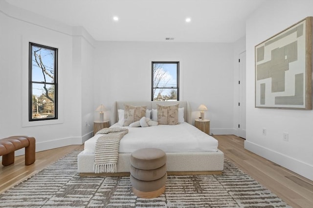 bedroom with hardwood / wood-style flooring