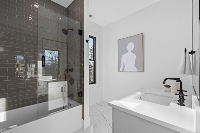 bathroom with bath / shower combo with glass door and vanity