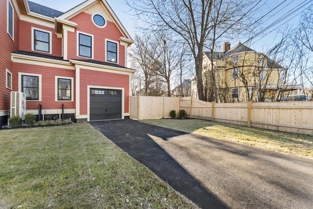 exterior space featuring a garage and a lawn