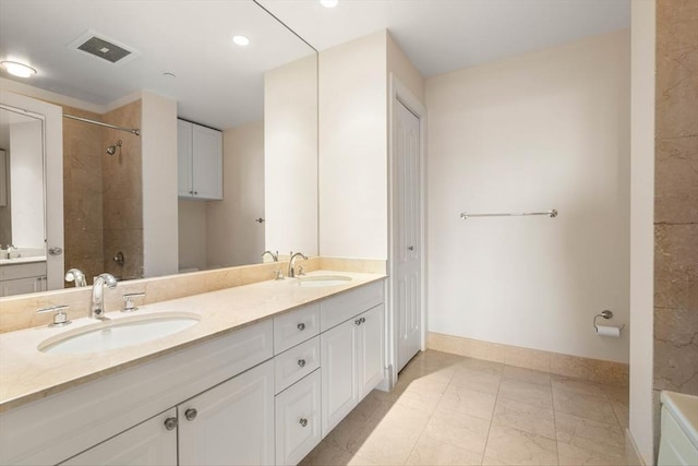 bathroom featuring vanity and a tile shower