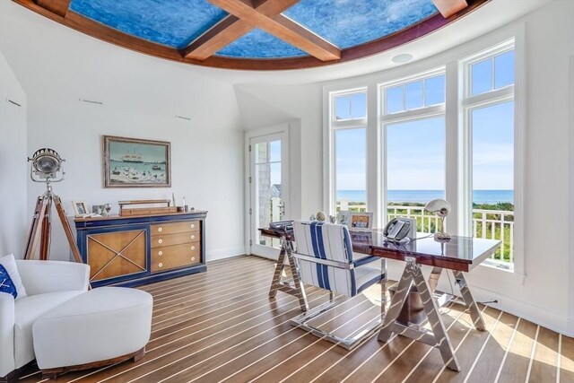 31 Moss Rd, Yarmouth, MA 02673 - dining space with wood finished floors, a water view, coffered ceiling, and a healthy amount of sunlight