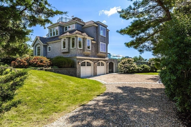 31 Moss Rd, Yarmouth, MA 02673 - view of front of home with a garage, driveway, and a front lawn