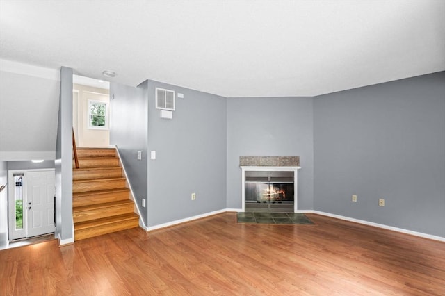 13 Fillmore Rd Unit 15Ab, Salem, MA 01970 - unfurnished living room featuring wood finished floors, a fireplace, and stairs