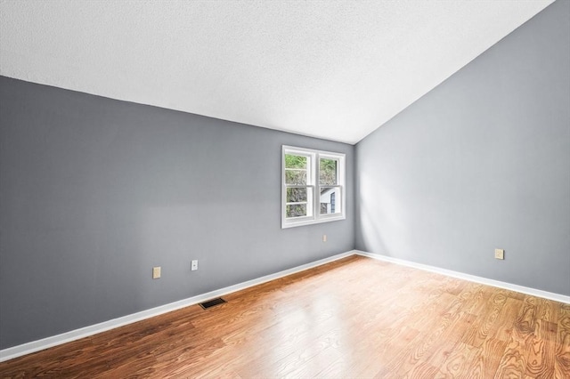 13 Fillmore Rd Unit 15Ab, Salem, MA 01970 - empty room featuring wood finished floors, lofted ceiling, and a textured ceiling
