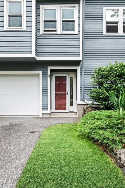 13 Fillmore Rd Unit 15Ab, Salem, MA 01970 - view of exterior entry featuring a garage and a yard