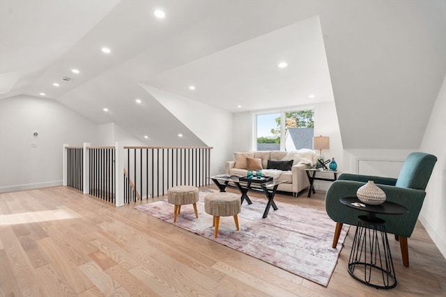 sitting room with light hardwood / wood-style floors and vaulted ceiling