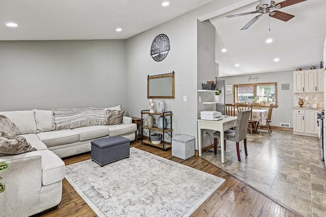 living room with ceiling fan, recessed lighting, wood finished floors, lofted ceiling, and visible vents