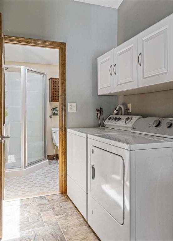 laundry area with cabinet space and washing machine and clothes dryer