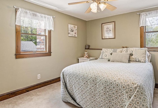carpeted bedroom featuring a ceiling fan and baseboards
