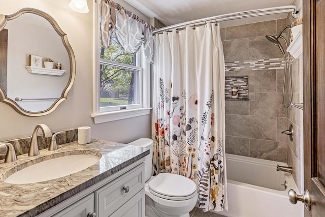 bathroom with toilet, shower / bathtub combination with curtain, and vanity