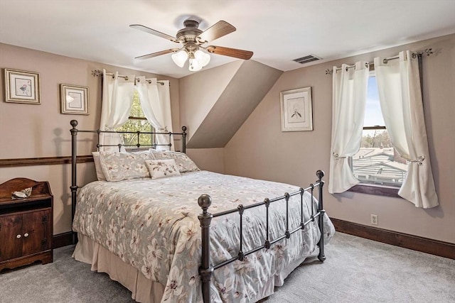 bedroom featuring visible vents, baseboards, a ceiling fan, carpet, and vaulted ceiling