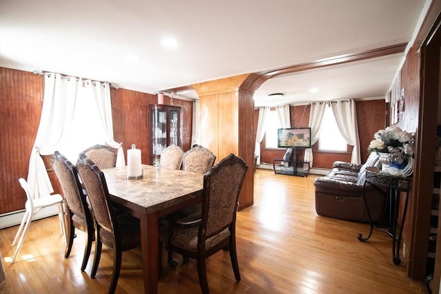 33 Cady St, Lowell, MA 01852 - dining space featuring light wood finished floors, wooden walls, and arched walkways