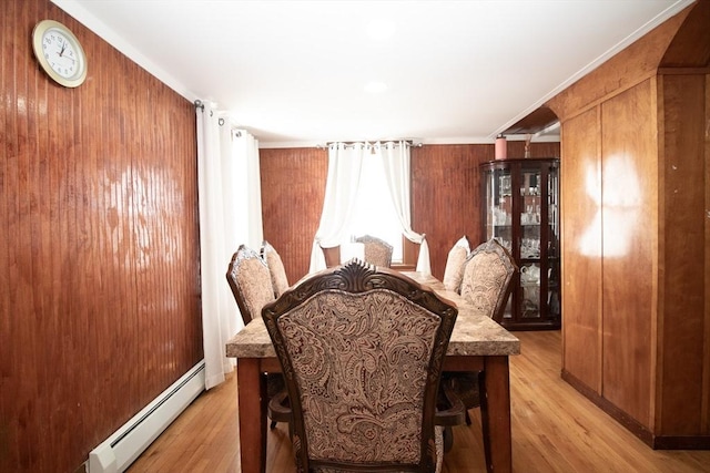 33 Cady St, Lowell, MA 01852 - dining space with a baseboard radiator, light wood-type flooring, and wooden walls