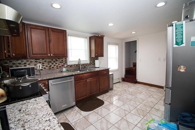 33 Cady St, Lowell, MA 01852 - kitchen with stainless steel appliances, a sink, decorative backsplash, range hood, and recessed lighting