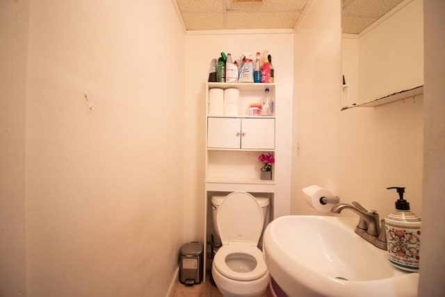 33 Cady St, Lowell, MA 01852 - half bath featuring a sink, toilet, baseboards, and tile patterned floors