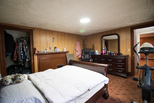 33 Cady St, Lowell, MA 01852 - bedroom with a closet, a textured ceiling, wood walls, and a walk in closet