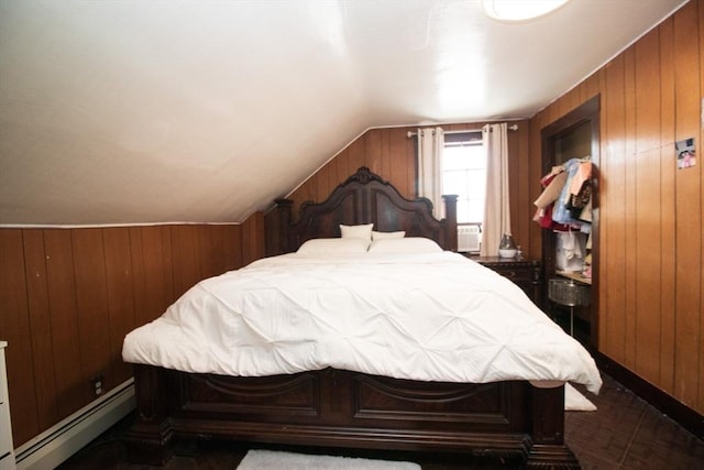 33 Cady St, Lowell, MA 01852 - bedroom featuring a baseboard heating unit, wood walls, and vaulted ceiling