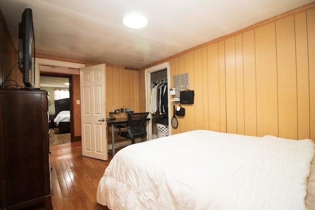33 Cady St, Lowell, MA 01852 - bedroom with dark wood-style floors and wood walls
