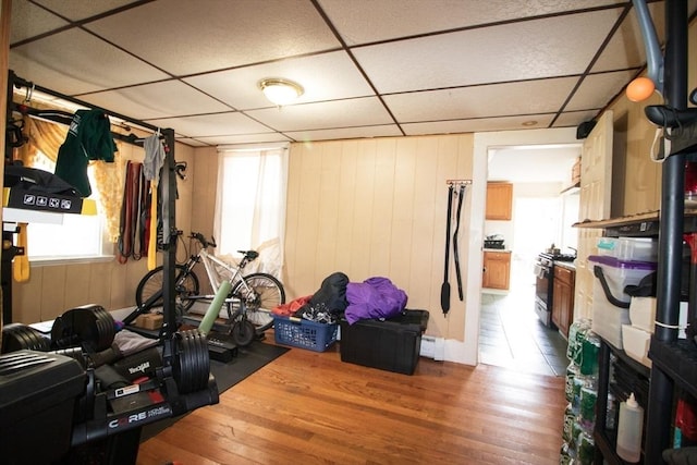 33 Cady St, Lowell, MA 01852 - exercise area featuring a drop ceiling, wood finished floors, and wood walls