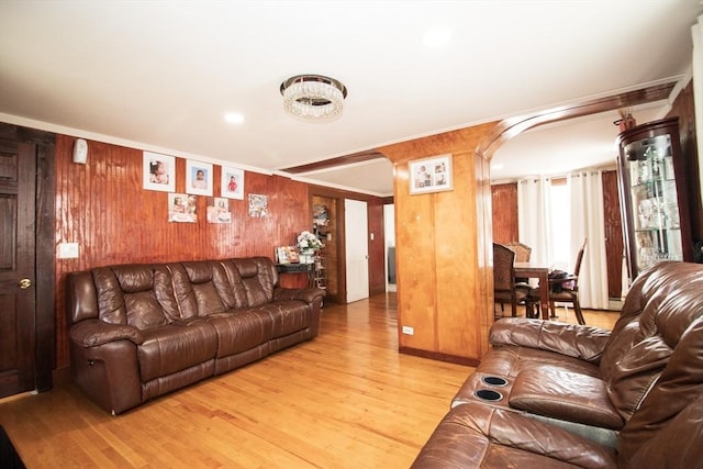 33 Cady St, Lowell, MA 01852 - living area featuring light wood-style floors, wooden walls, arched walkways, and recessed lighting