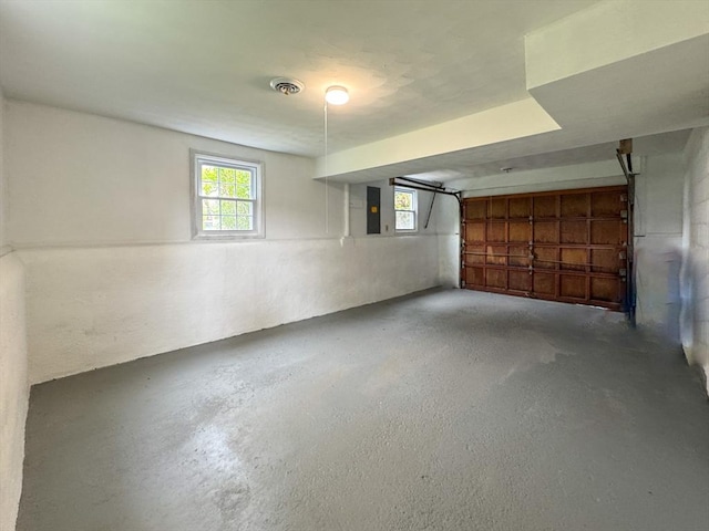 basement featuring a garage and plenty of natural light