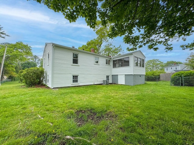 rear view of property featuring cooling unit and a chimney