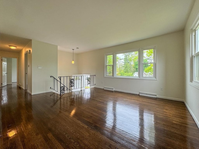 unfurnished room featuring hardwood / wood-style floors, a baseboard radiator, and baseboards