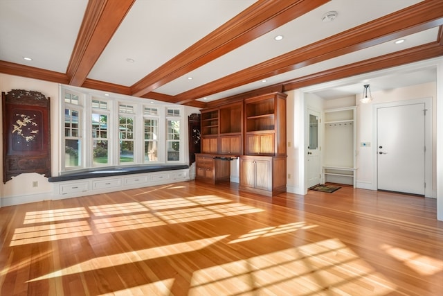 unfurnished living room with hardwood / wood-style flooring, beamed ceiling, and crown molding