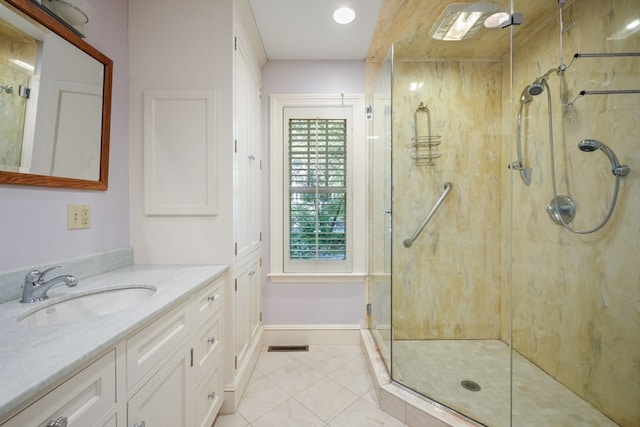 bathroom with vanity, a shower with shower door, and tile patterned flooring