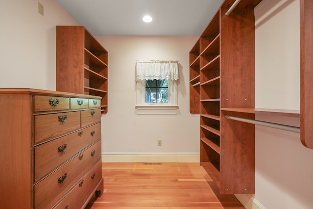 spacious closet with light hardwood / wood-style flooring