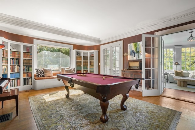 recreation room featuring wood-type flooring, french doors, and crown molding