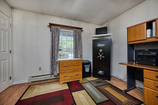 10 Phillips Dr, Colrain, MA 01340 - kitchen featuring wood finished floors, brown cabinetry, vaulted ceiling, and baseboard heating