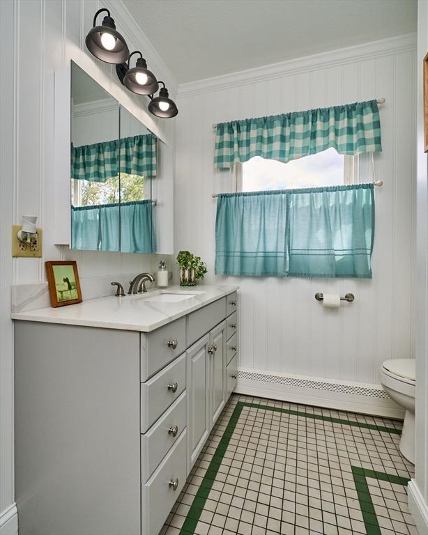 10 Phillips Dr, Colrain, MA 01340 - bathroom featuring plenty of natural light, toilet, vanity, ornamental molding, and tile patterned flooring